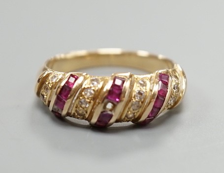 A modern 585 yellow metal, ruby and diamond chip set half hoop ring, size M/N, gross weight 3.3 grams.